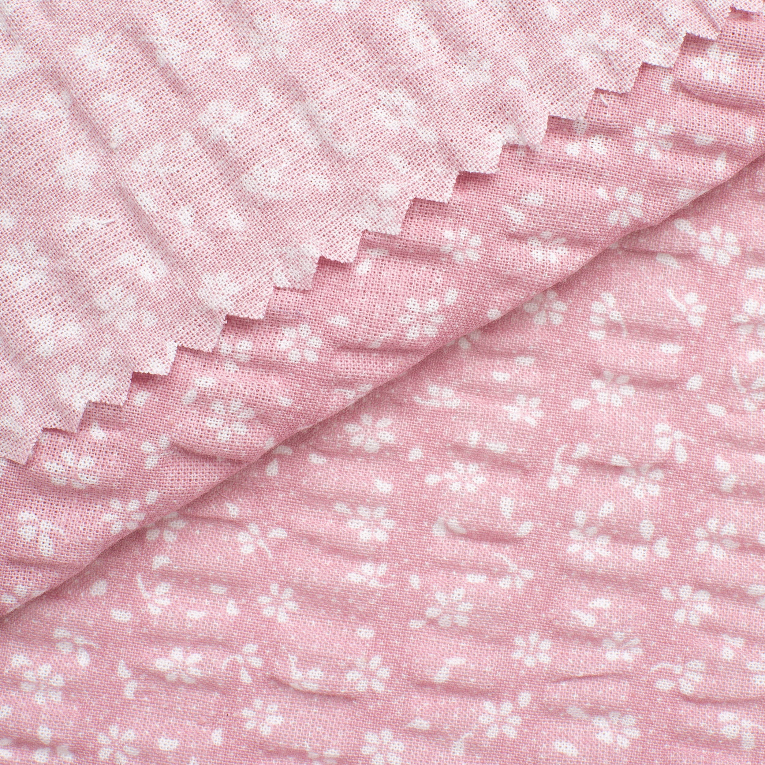 PRINTED COTTON SEERSUCKER FABRIC - SMALL WHITE FLOWERS ON PINK BACKGROUND - 160 GSM